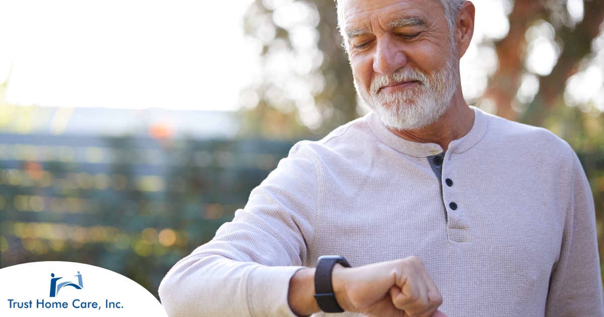 A senior man wears a smart watch, representing one of the many ways smart technology is shaping home health care.