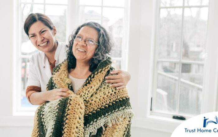 A caregiver hugs an older client representing the kind of good environment a caregiver has the potential to create with new clients.