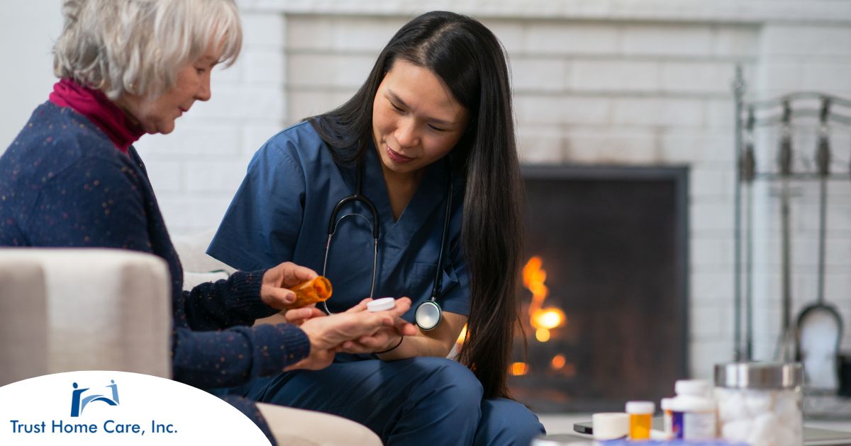 Empowering-Patients-The-Role-of-Home-Health-Nurses-in-Chronic-Disease-Management A nurse helps a patient at home with her medications, representing how home health nurses can help with disease management.
