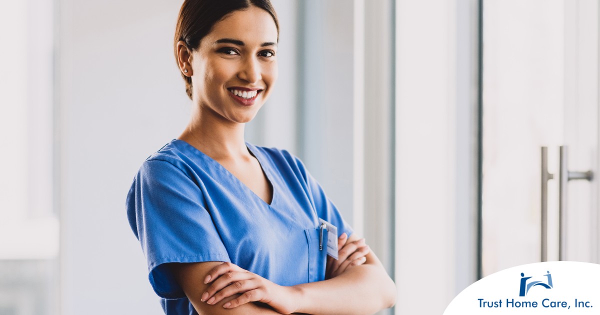 How-to-Become-a-Home-Health-Aide-A-Step-by-Step-Guide-to-Starting-Your-New-Career A woman in scrubs smiles representing the satisfaction of finding out how to become a home health aide.