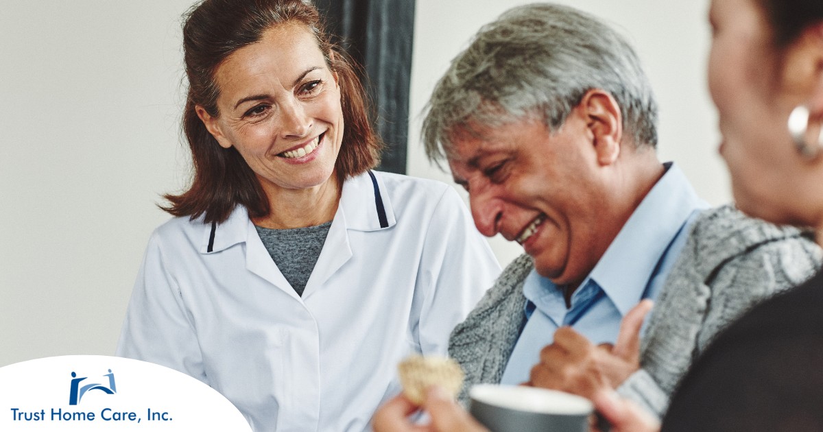 Navigating-the-Landscape-of-Senior-Caregiver-Jobs-Finding-the-Right-Fit A woman smiles while with clients showing how you can enjoy senior caregiver jobs.