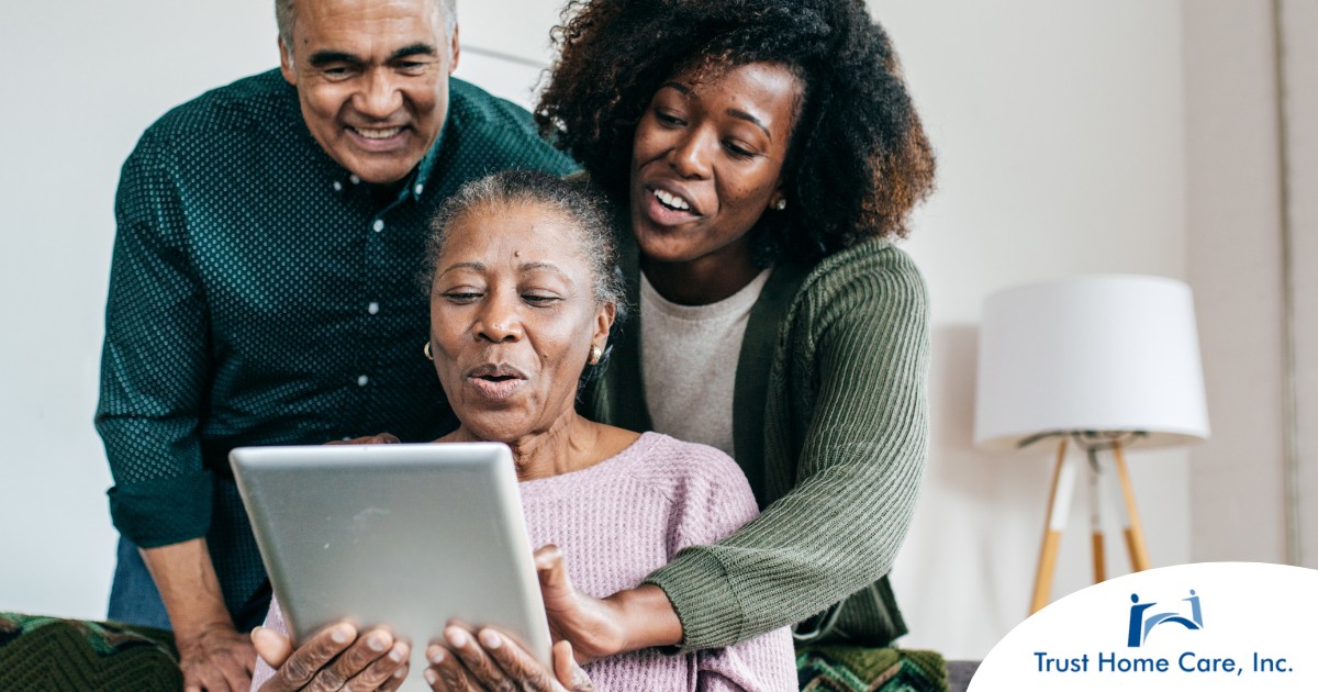 Smart-Homes-Smart-Lives-Aging-in-Place-with-Technology A daughter looks at a tablet with her older parents, representing technology and how ti can help with aging in place.