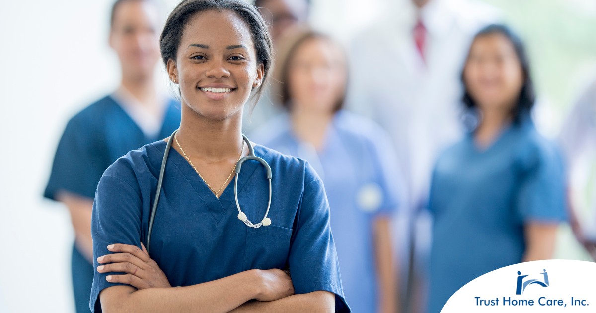 Starting-Strong-Essential-Skills-for-a-New-Home-Health-Care-Job A woman in scrubs with a healthcare team behind her represents starting a new home health care job with a confident approach.