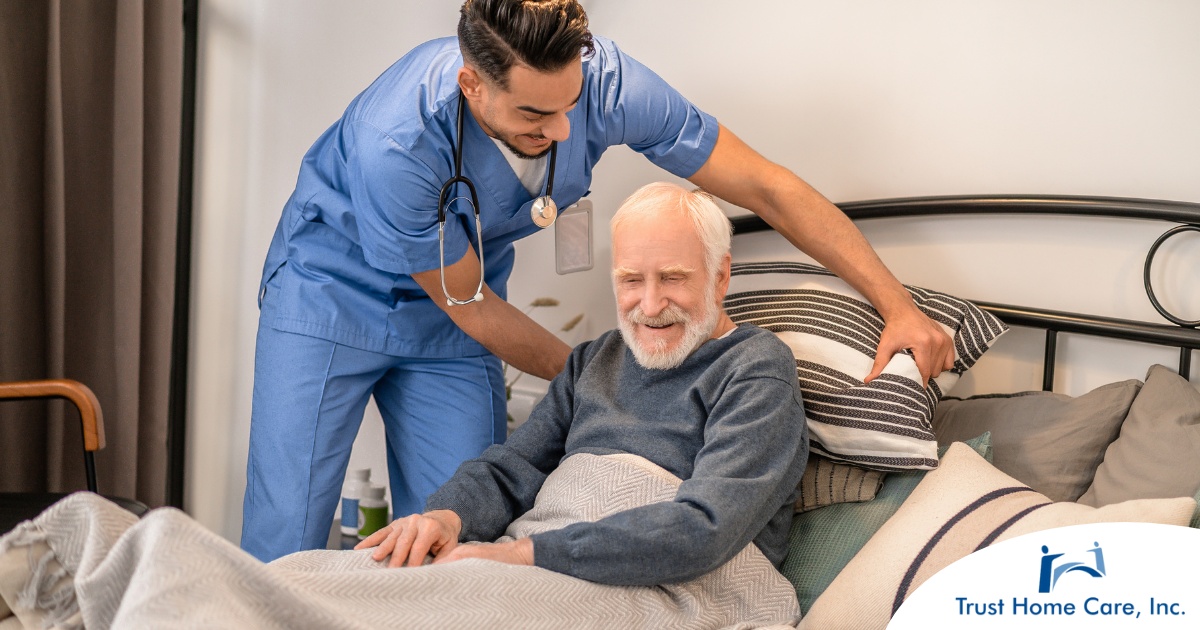 Staying-Safe-in-Home-Health-Care-Best-Practices-and-Precautions A home health care worker helps a patient in bed while both smile representing the results of a safe work habits.