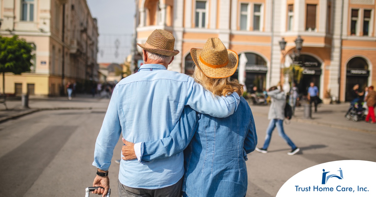 Traveling-with-Elderly-Loved-Ones-Tips-for-Caregivers-on-the-Go 2 older adults hug while on vacation representing the successful outing that can still happen while caring for elderly loved ones.