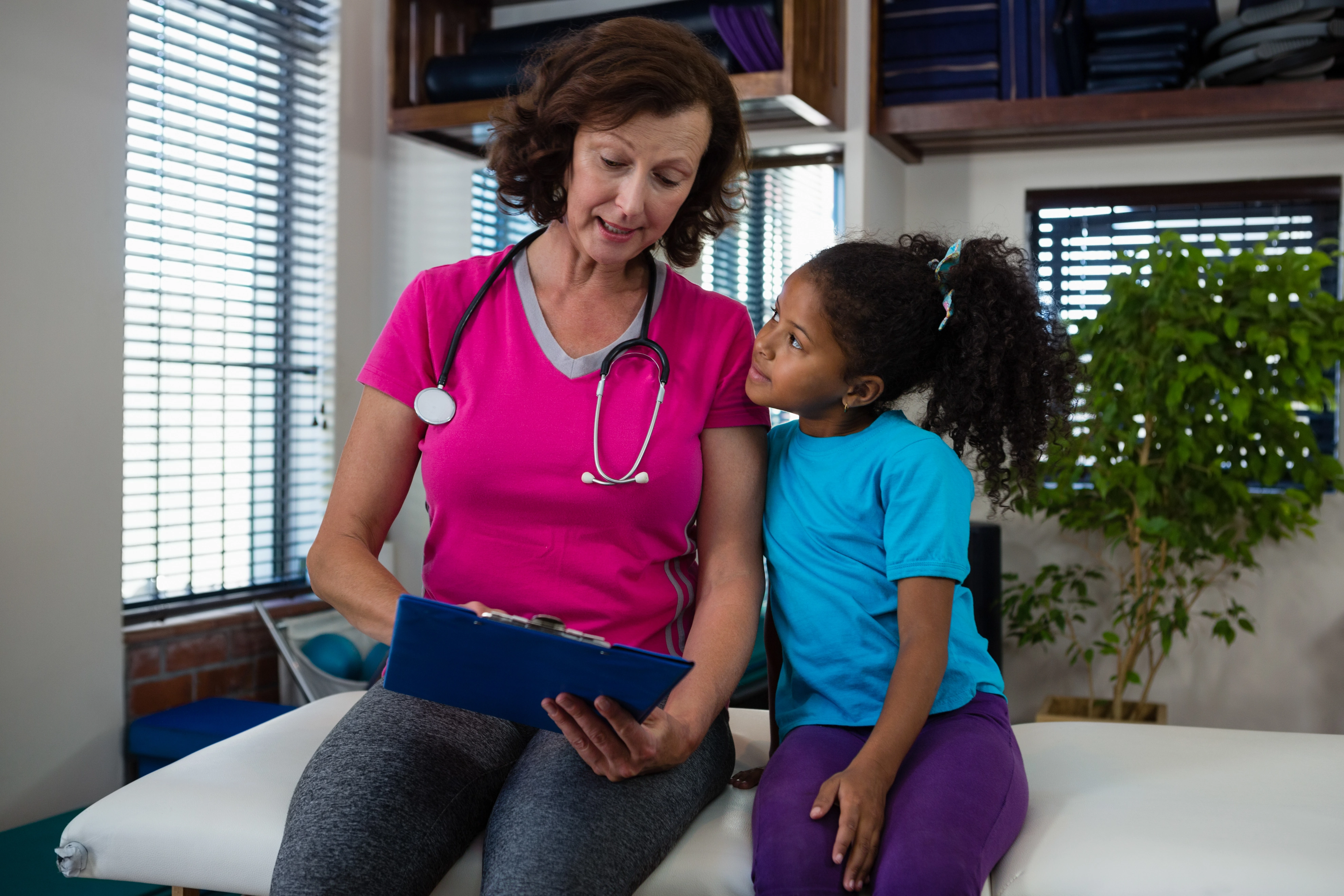 Caregiver reviewing a care plan with a child during in-home autism care in Bowie, MD