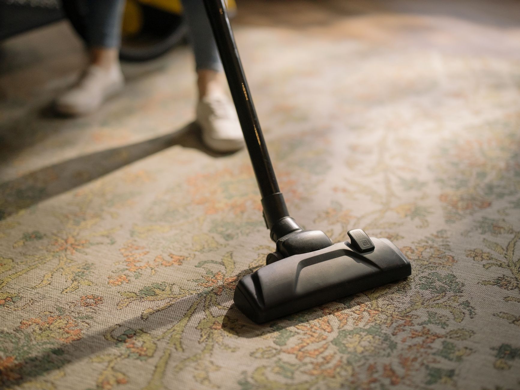 Vacuuming carpets to keep walkways clear during homemaker services in Sterling, VA