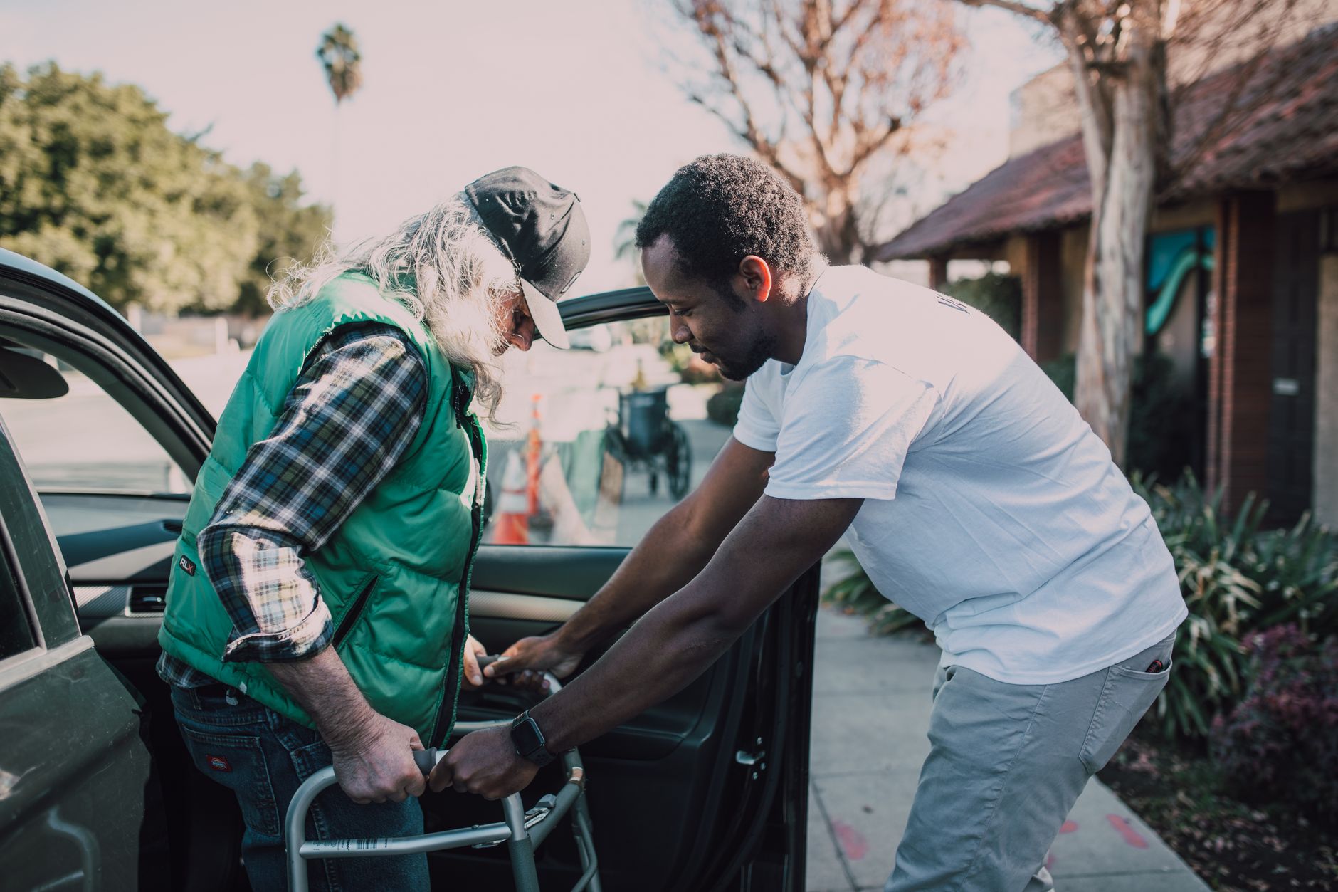 A caregiver helping a senior with a walker move safely during occupational therapy in Sterling, VA